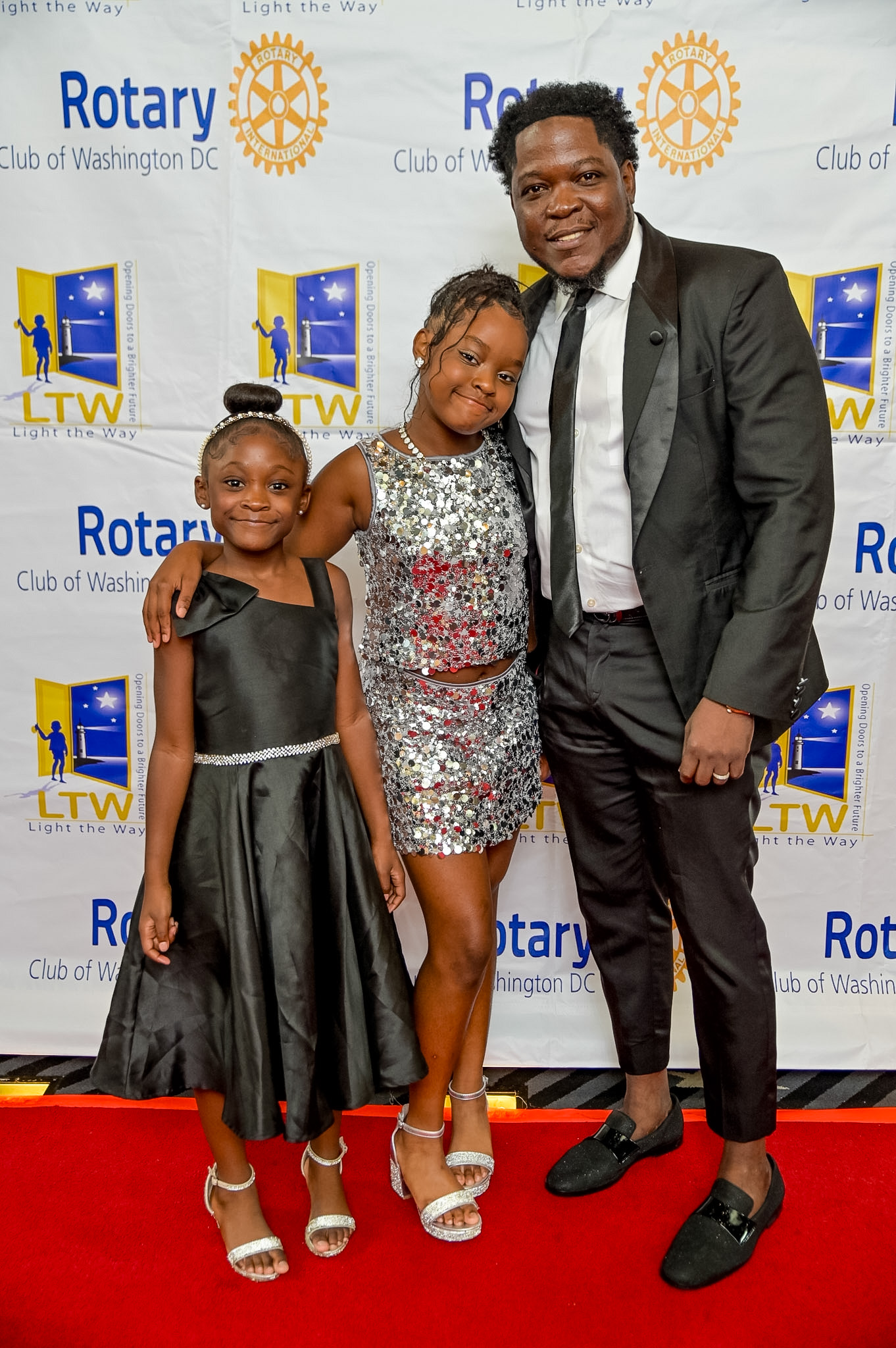 Two girls and a man posing on the Red Carpet at the 2026 Premiere