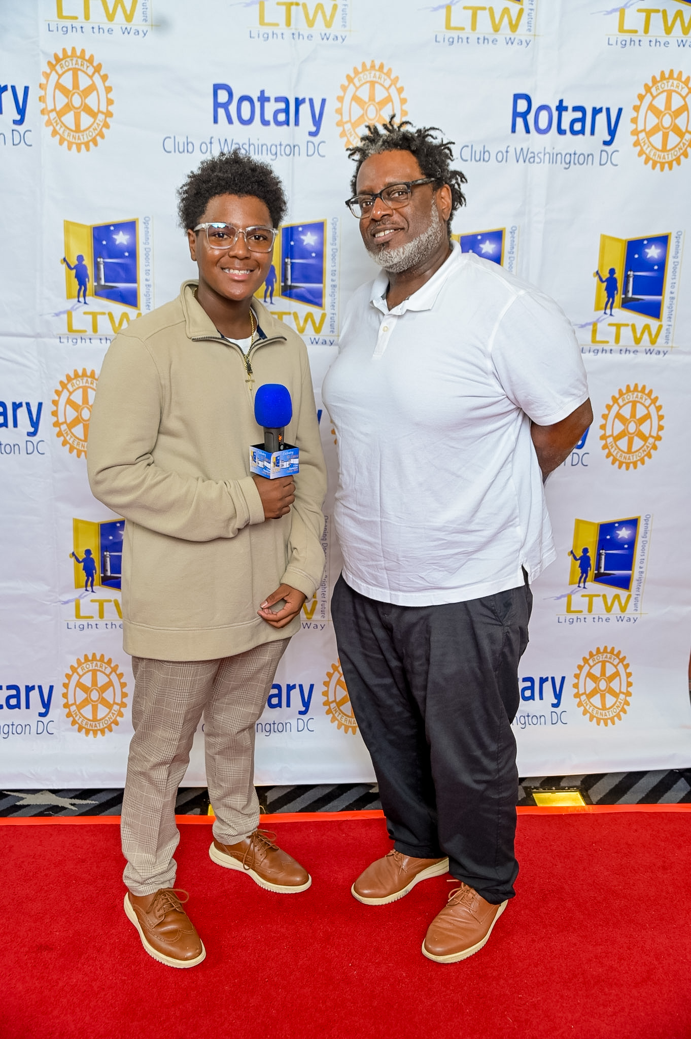 Two guests with a microphone posing on the Red Carpet at the 2026 Premiere