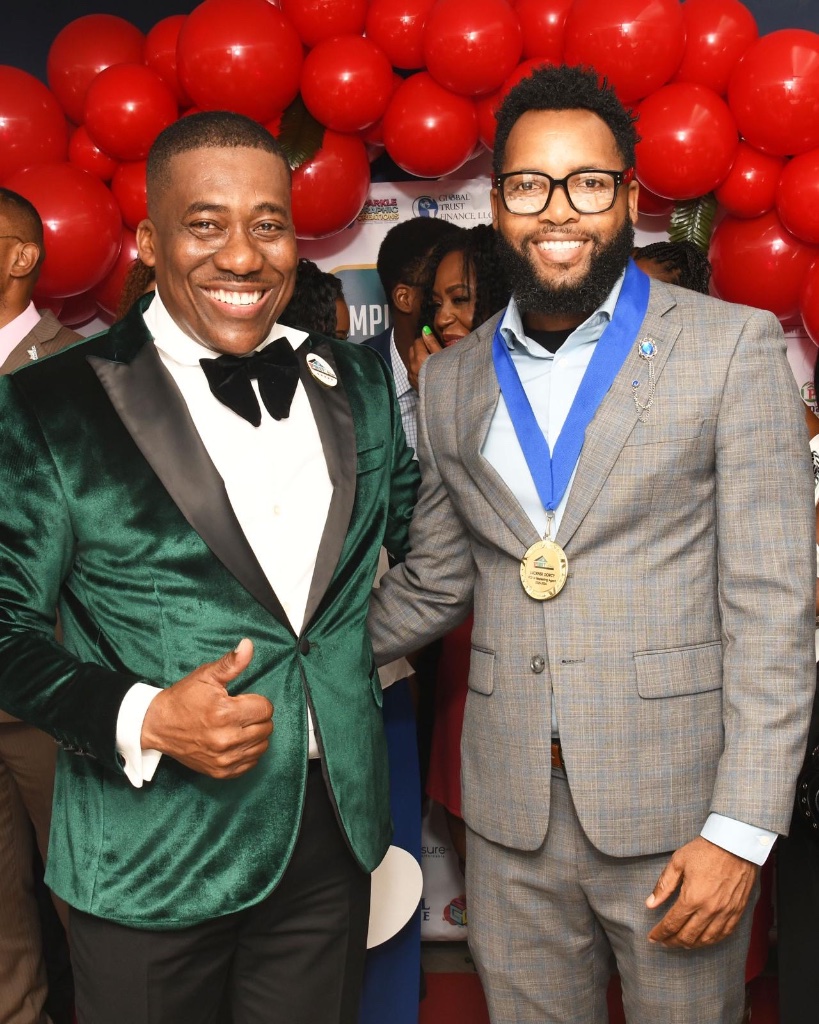 Luckner Dorcy with a client at an event