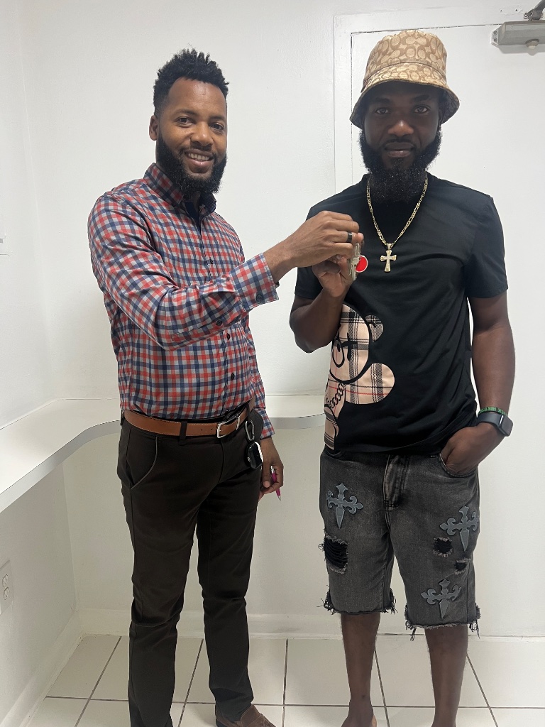Real estate agent handing keys to a new client at closing
