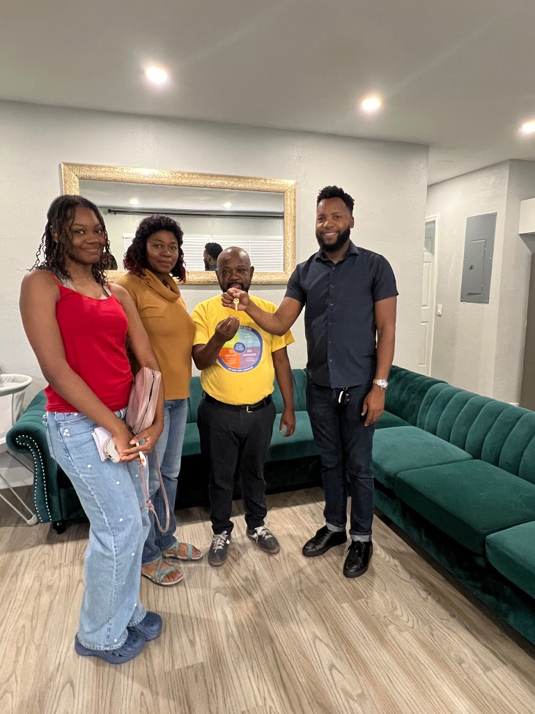 Clients receiving their keys from Luckner Dorcy