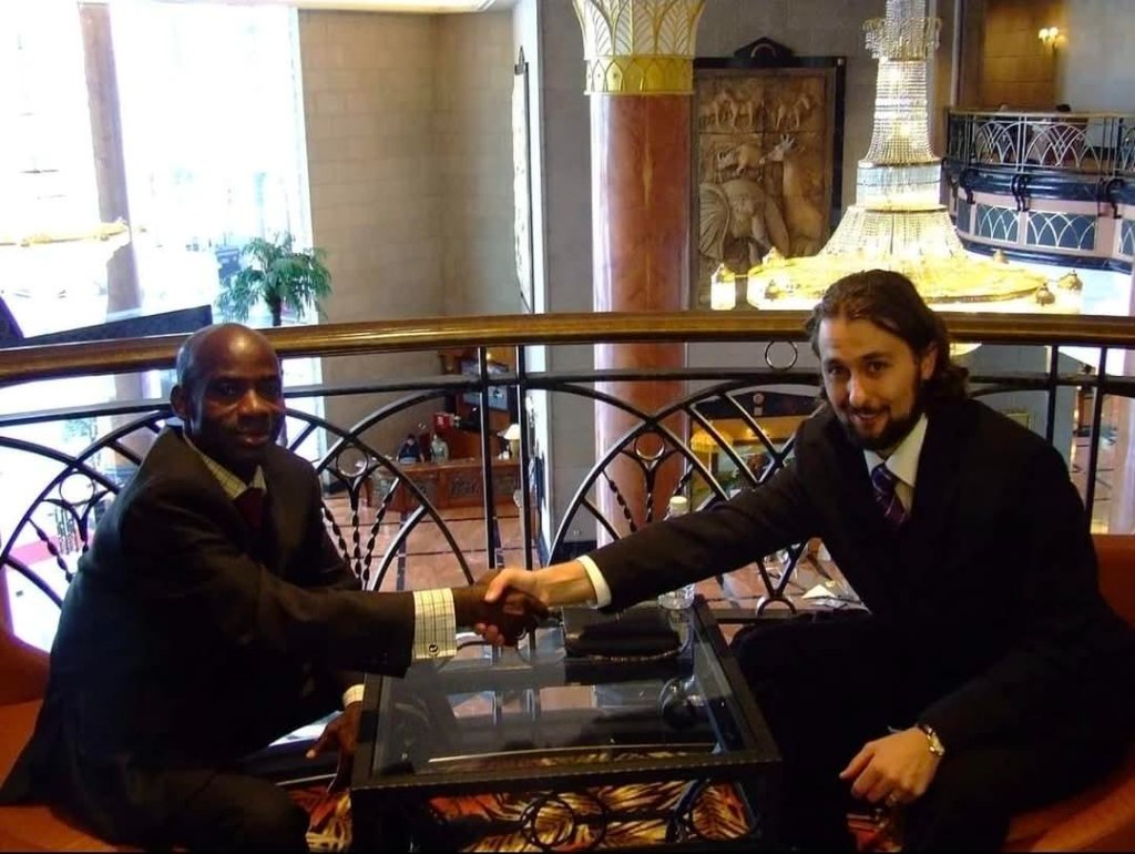 Eliahi Priest shaking hands with Aloise Makoule Goma at the World Peace Congress
