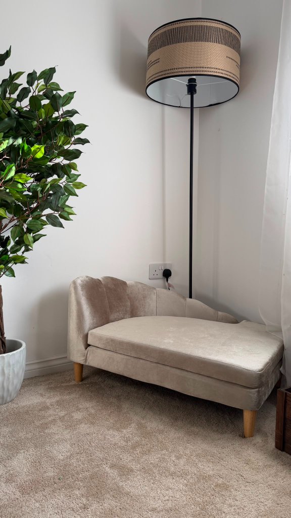 A scallop-tufted cream velvet pet chaise lounge in the Retreat Room at House of Paws Retreat — a stylish, calming spot for a guest dog to recline and unwind between walks
