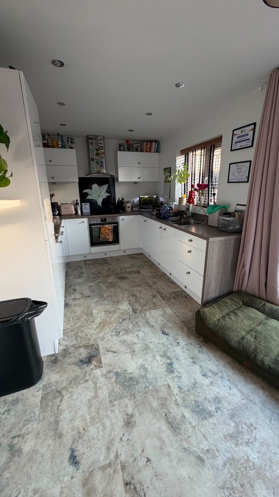 The bright, clean kitchen at House of Paws Retreat — where meals and treats are freshly prepared, with a calm dog bed tucked into the corner