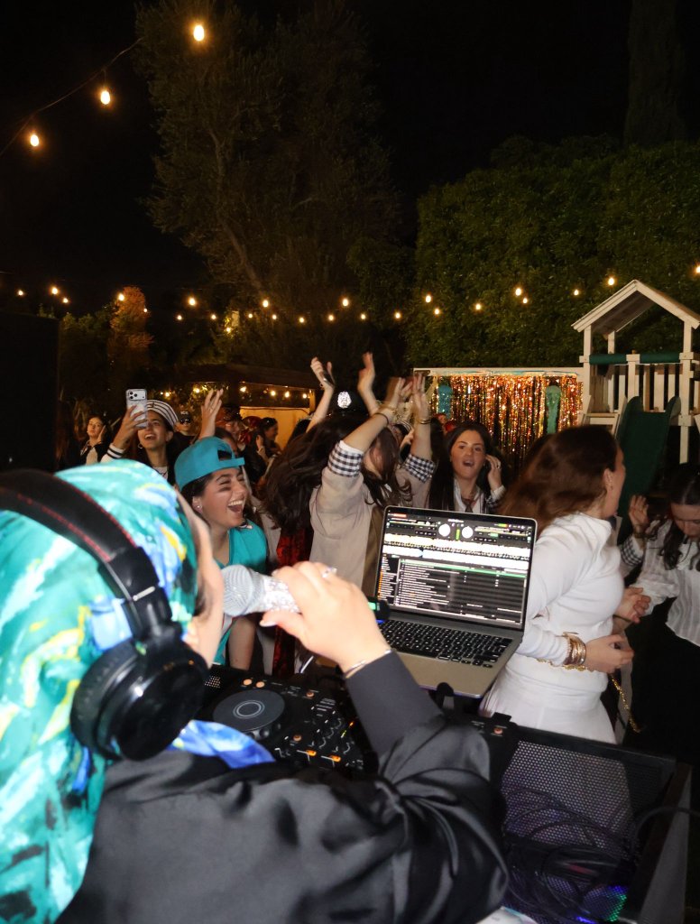 DJ Razi with dancing crowd at night