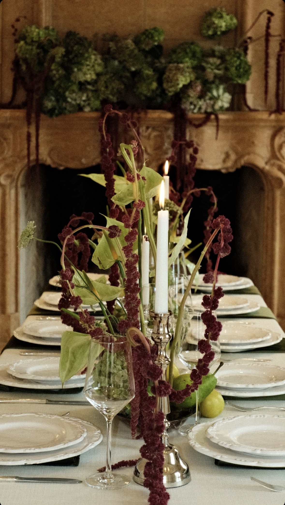 Minimalist floral centerpiece on marble pedestal overlooking misty coastline