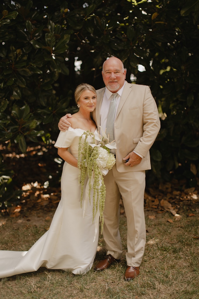Bride and father portrait with cascading green and white bouquet