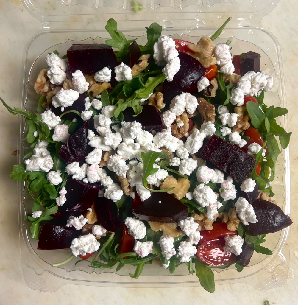 Fresh gourmet salad with mixed greens, mozzarella balls, cherry tomatoes and balsamic dressing