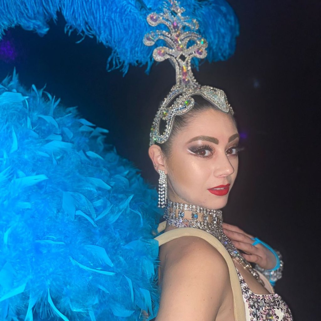 Showgirl close-up portrait with blue feathers