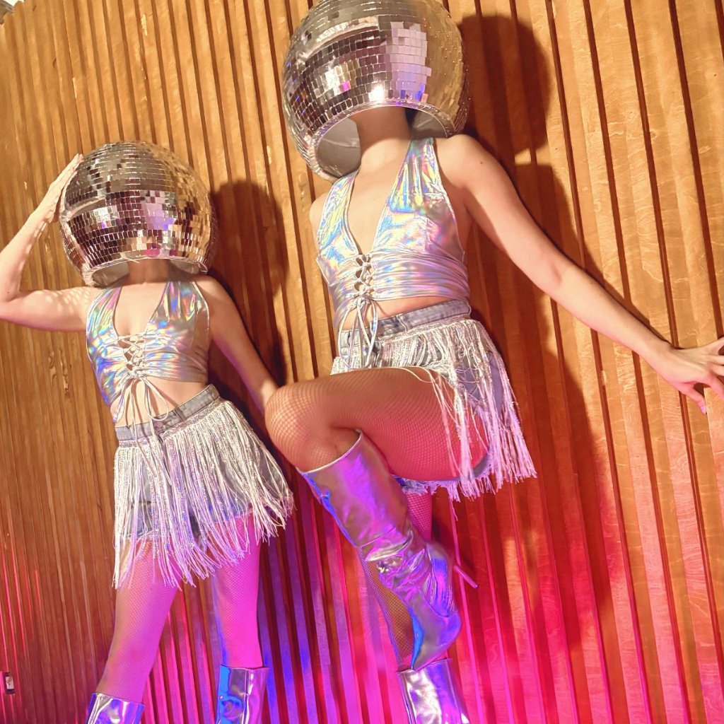 Two disco ball head showgirls holographic London