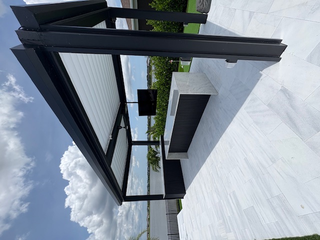 Custom outdoor kitchen with louvered pergola in Melbourne, Florida