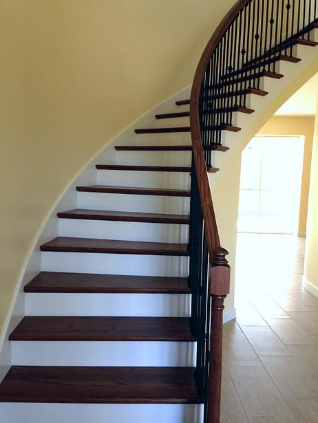 Curved Staircase — Dark Treads & Iron