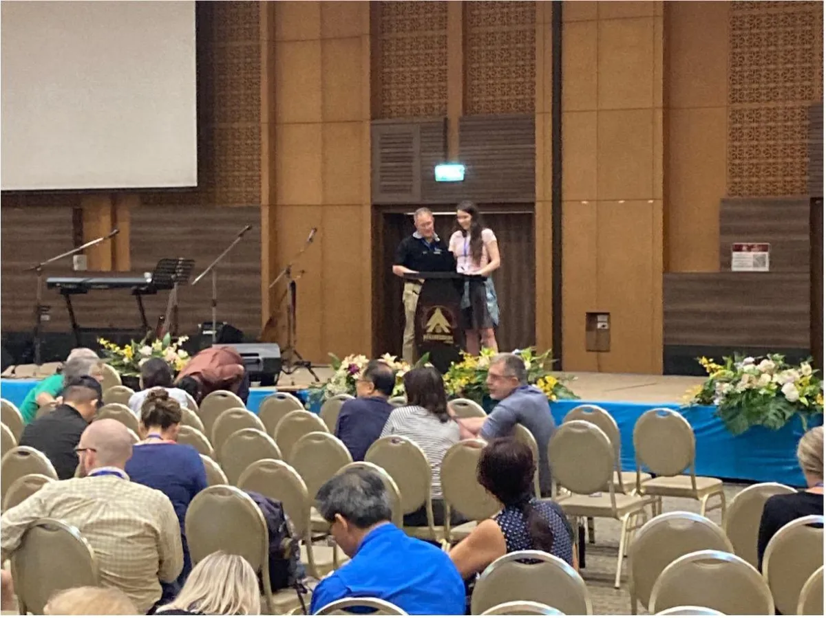 Calley presenting at the conference podium