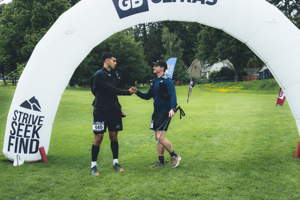 DVOTION founder Chris Gkoufas and fellow DVOTION coach at the GB Ultras finish line after completing Ultra Scotland 104-mile race, June 2026