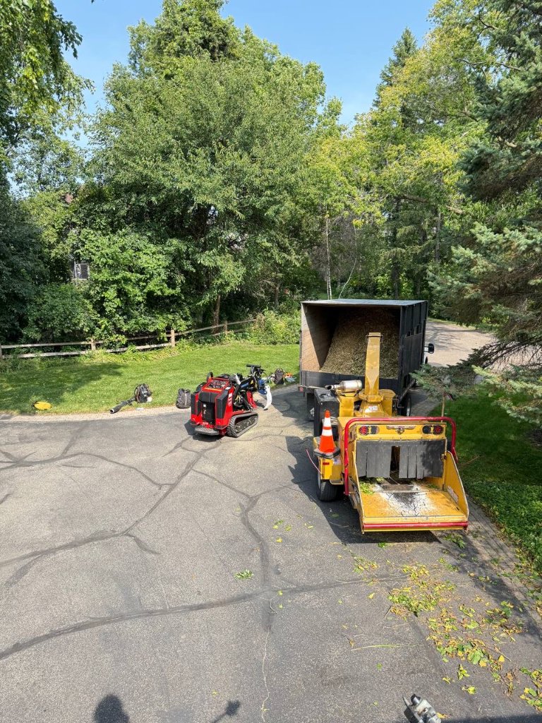 Chipper & Skid Steer — Debris Hauling Operation