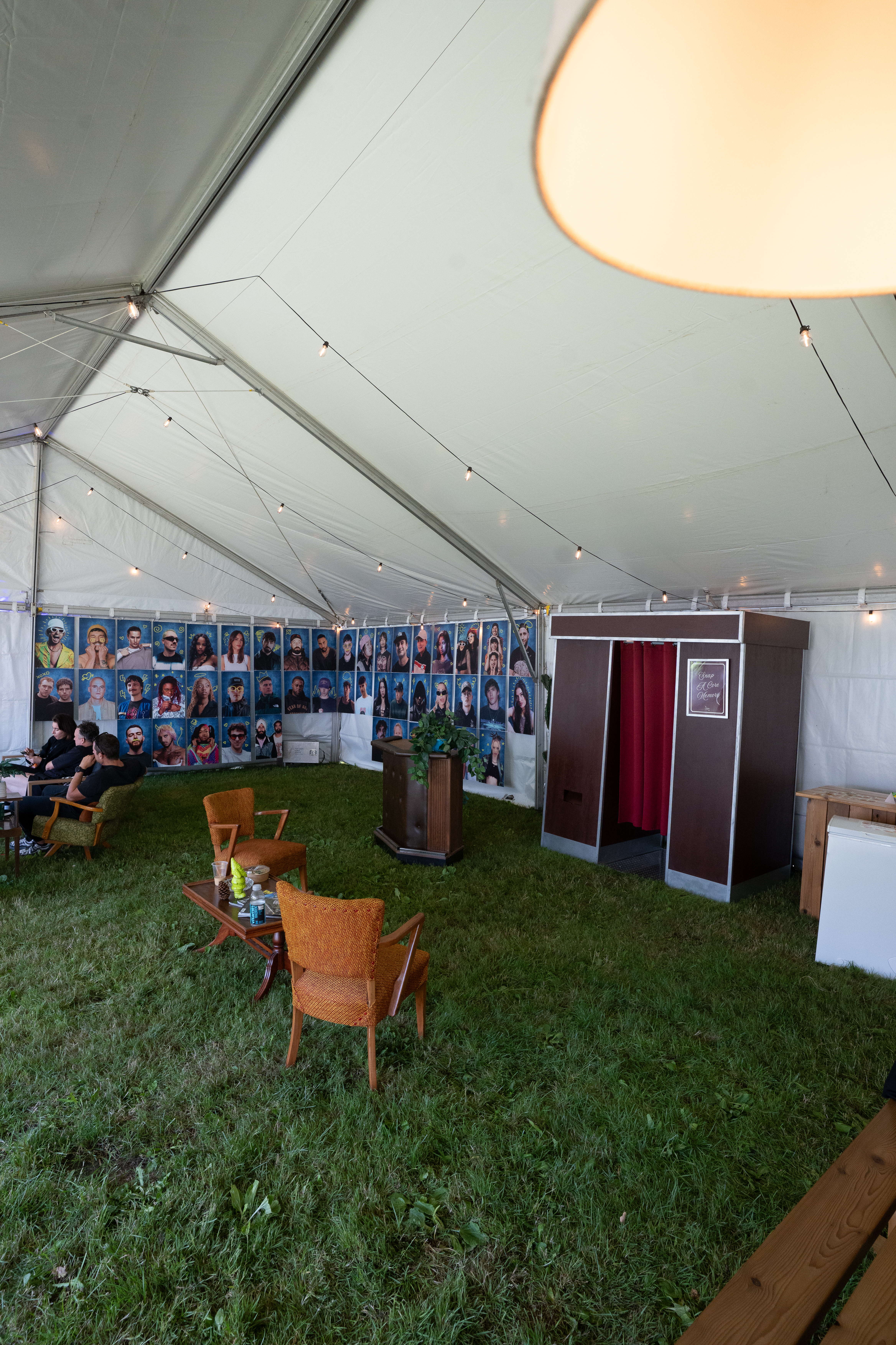The Retro Booth's vintage cabinet set up under a tent with lounge seating at Fvded in the Park