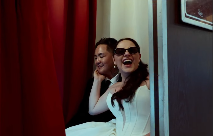 Guests laughing inside The Retro Booth's enclosed vintage photo booth