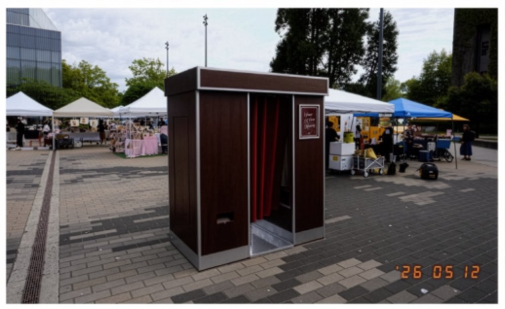 The Retro Booth's enclosed, vintage-styled photo booth set up outdoors at a Vancouver event