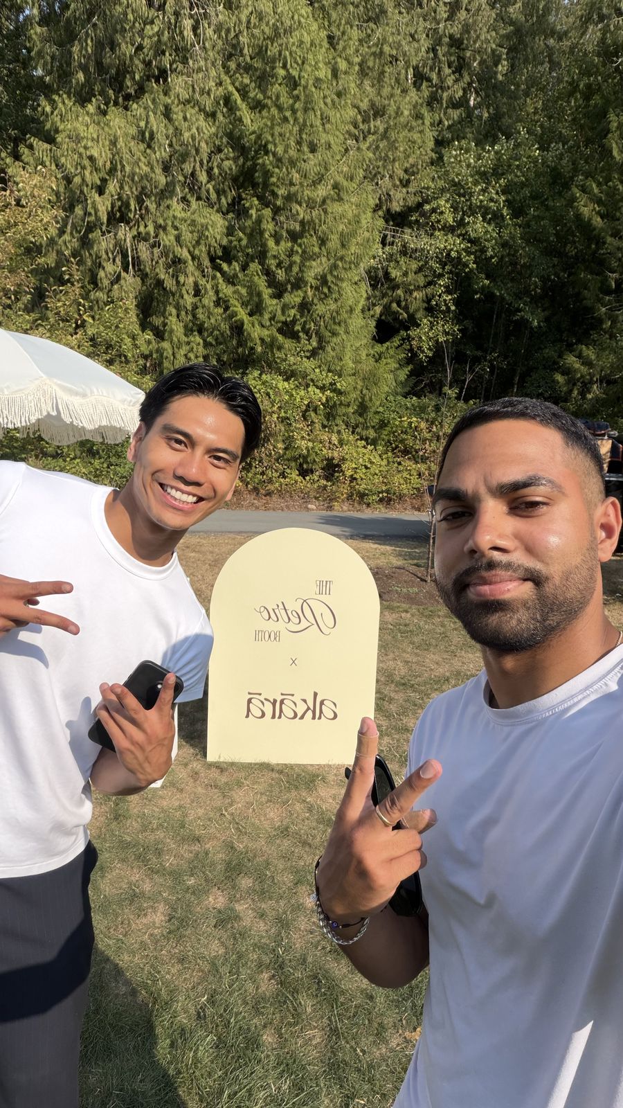 Two guests taking a selfie beside the Retro Booth x Akara sign at the Akara Pilates event in Langley