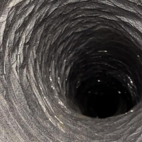 Dirty flexible air duct clogged with dust and debris before professional cleaning San Antonio TX