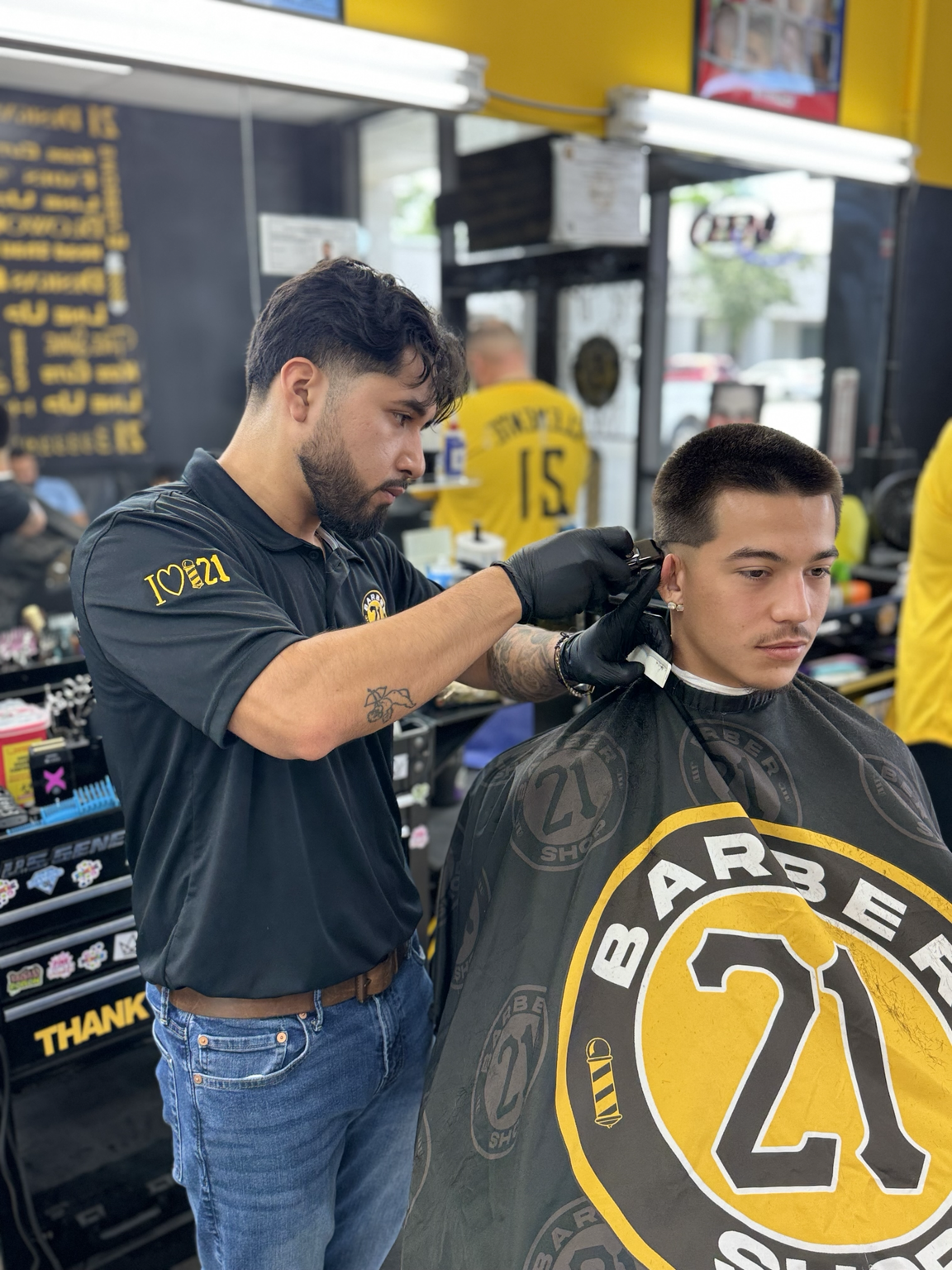 Barber cutting hair at shop