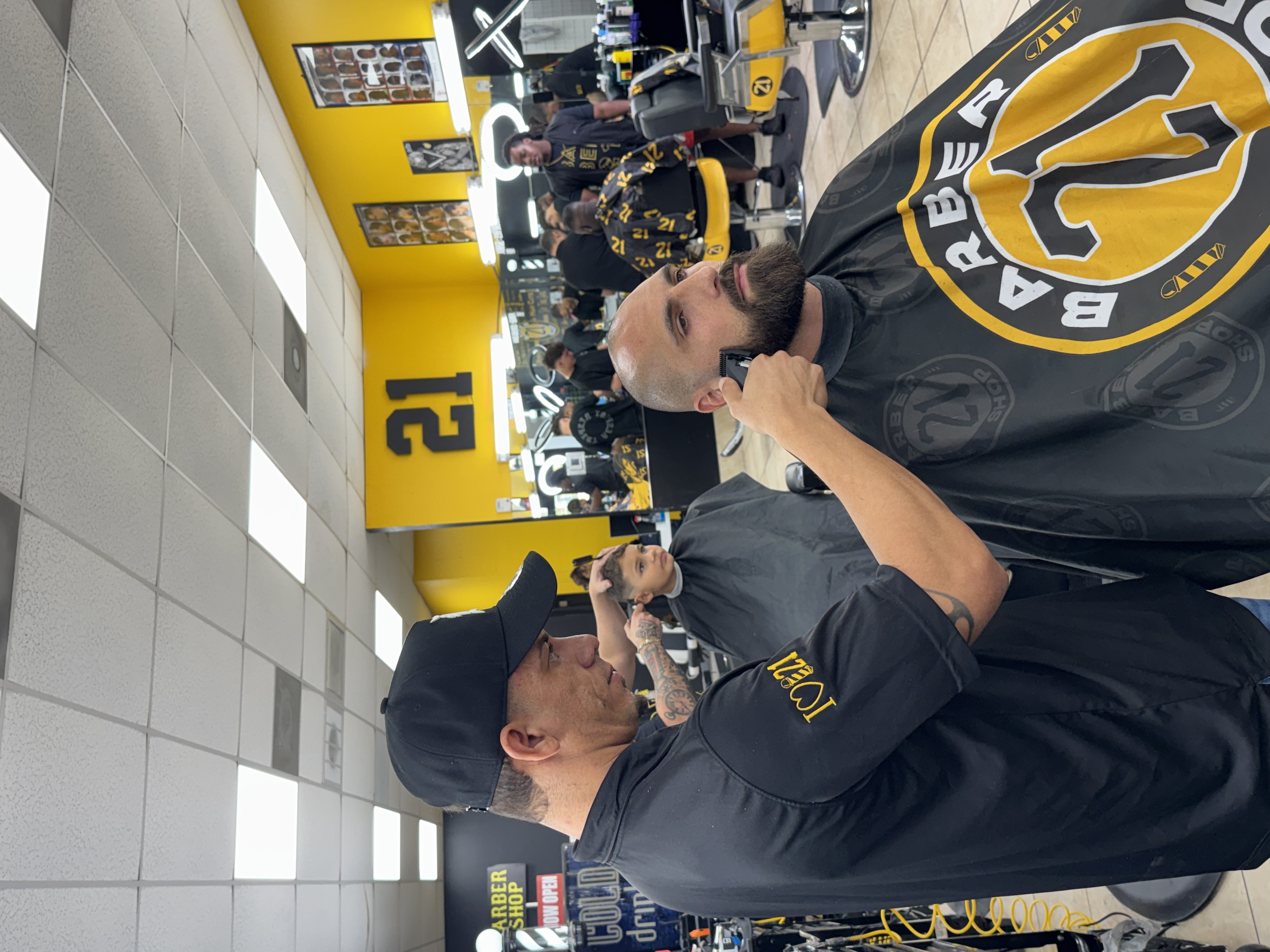 Barber trimming beard with clippers