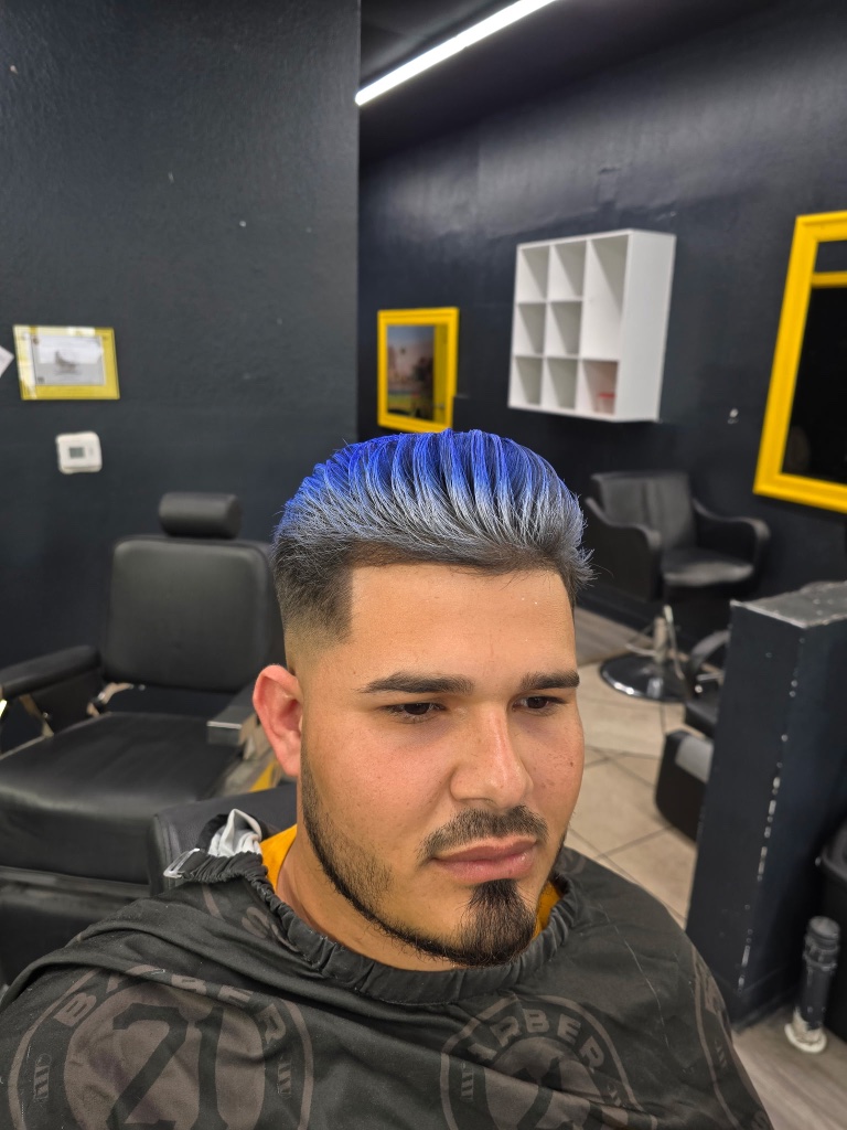 Blue-dyed top fade with goatee