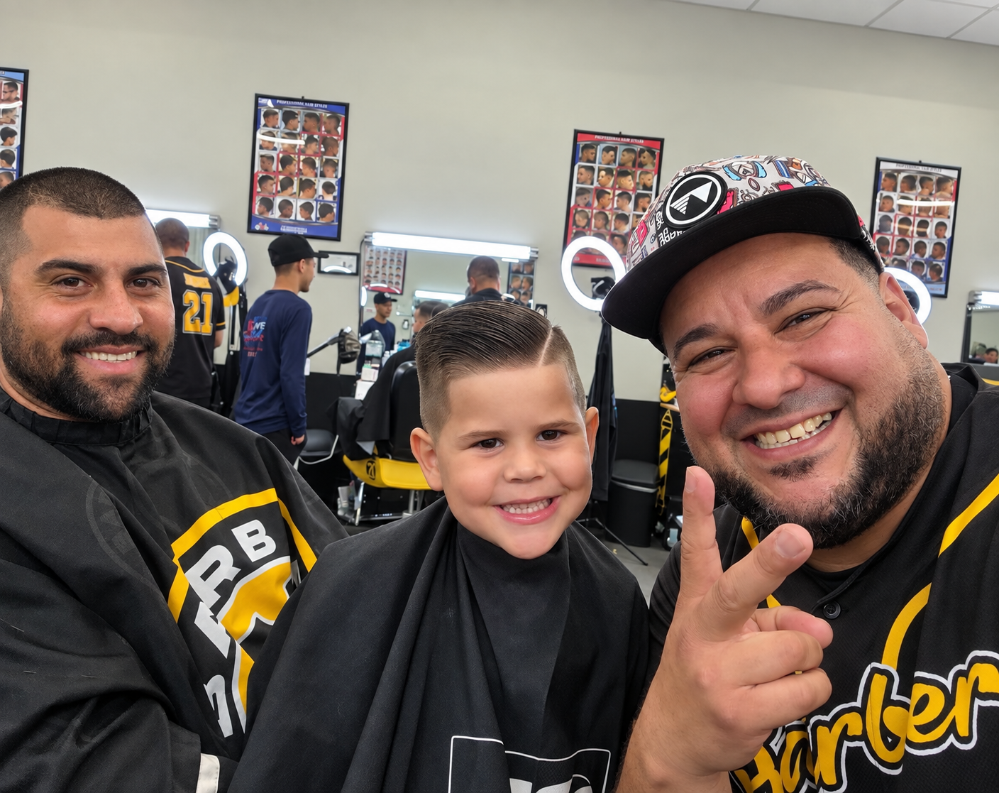 Barbers with young client in shop