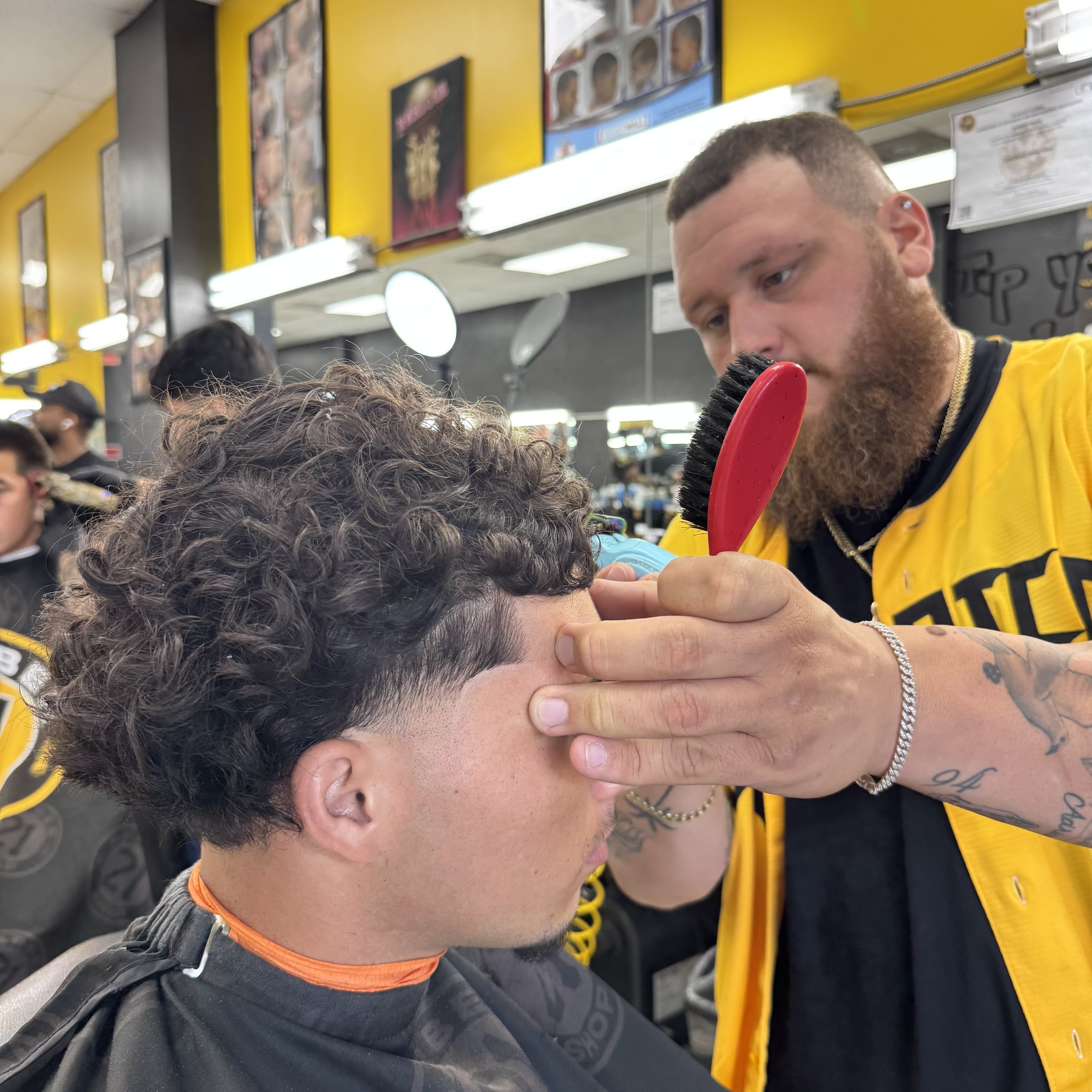 Barber brushing curly hair