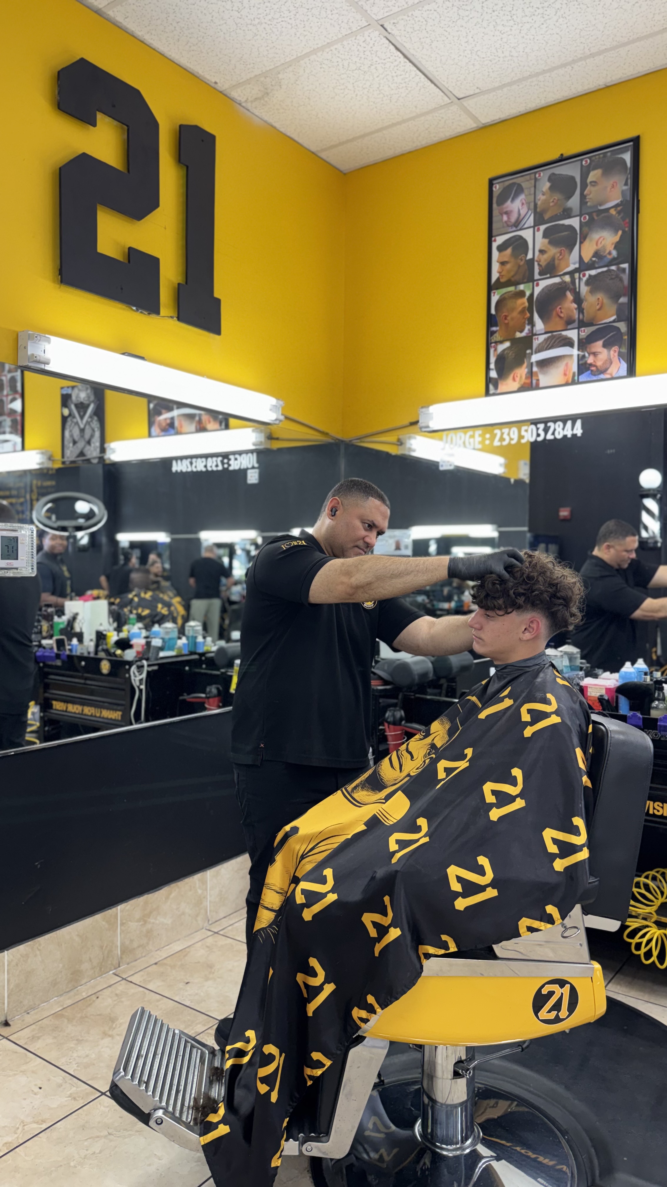 Barber grooming young client