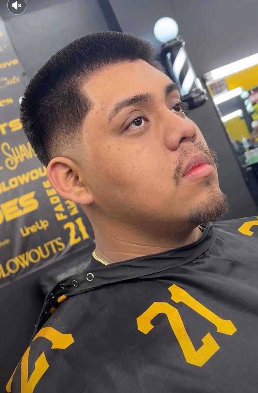 Client with low fade in barber chair