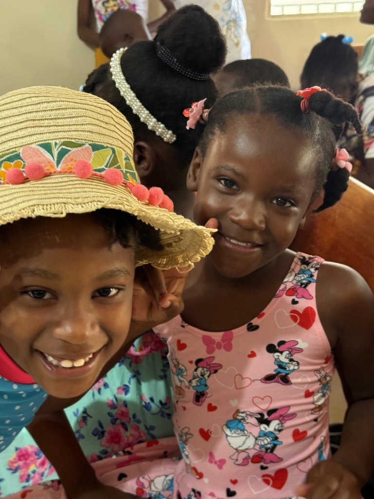 Two young girls smiling at the camera