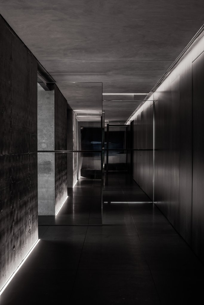 The mirrored pivot-door corridor