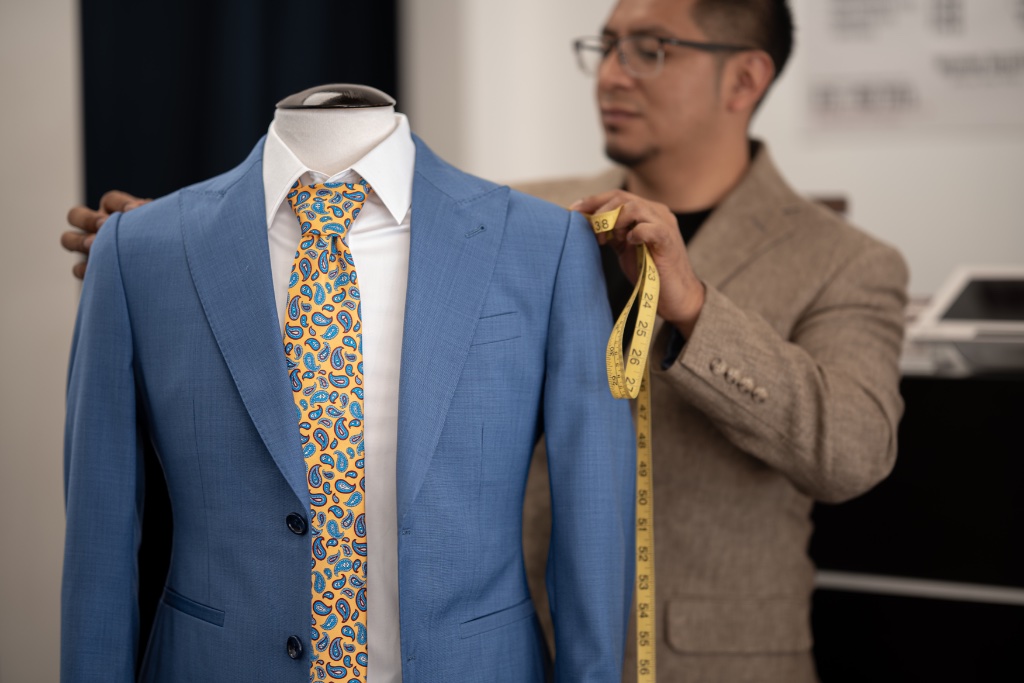 Blue suit with yellow paisley tie on mannequin