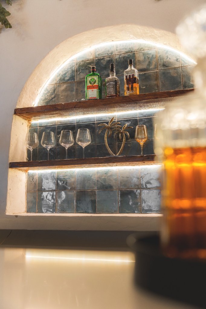 A Casa bar shelves with wine glasses
