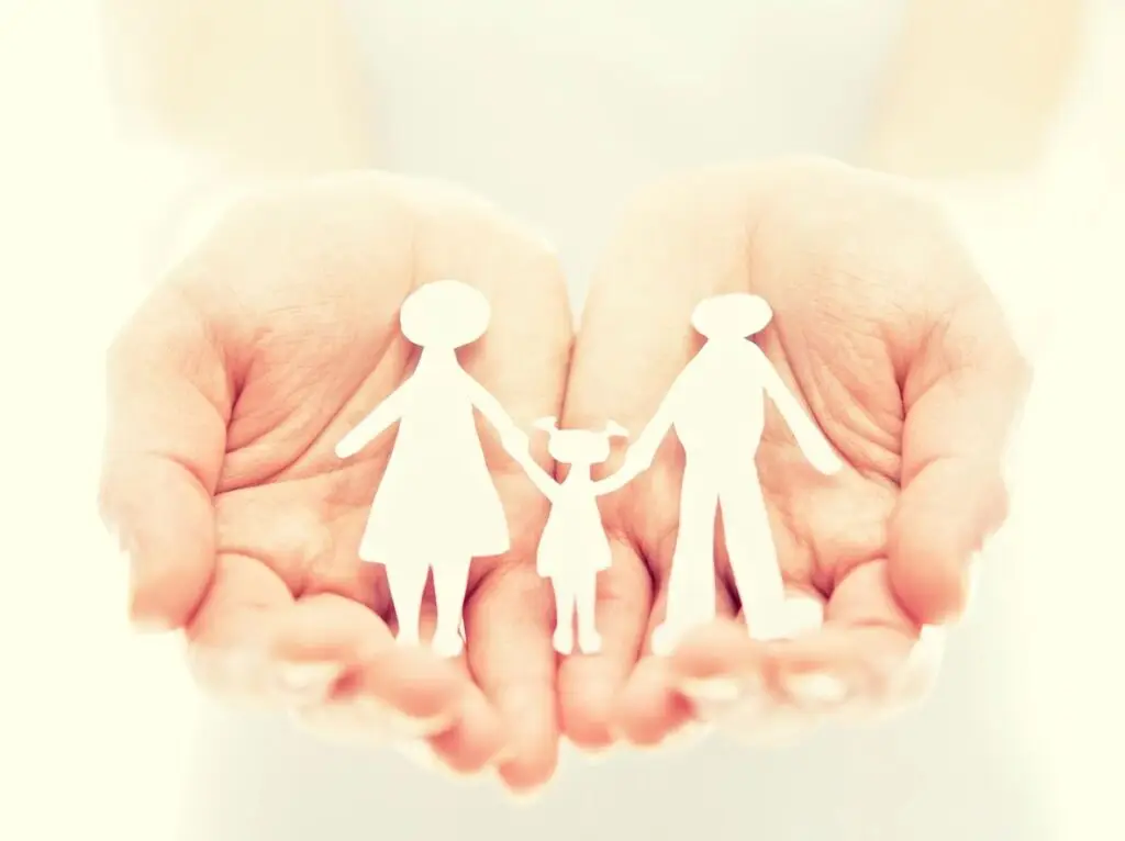 Caring hands holding a family