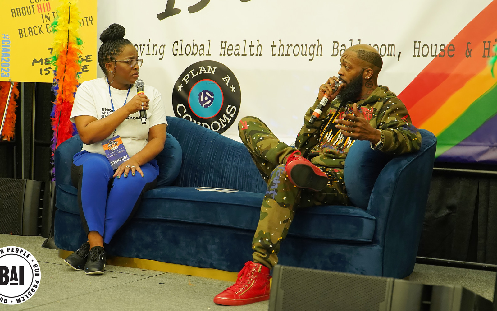Two speakers recording a podcast conversation with microphones at the BAI CIAA event — Bmore Pro Productions