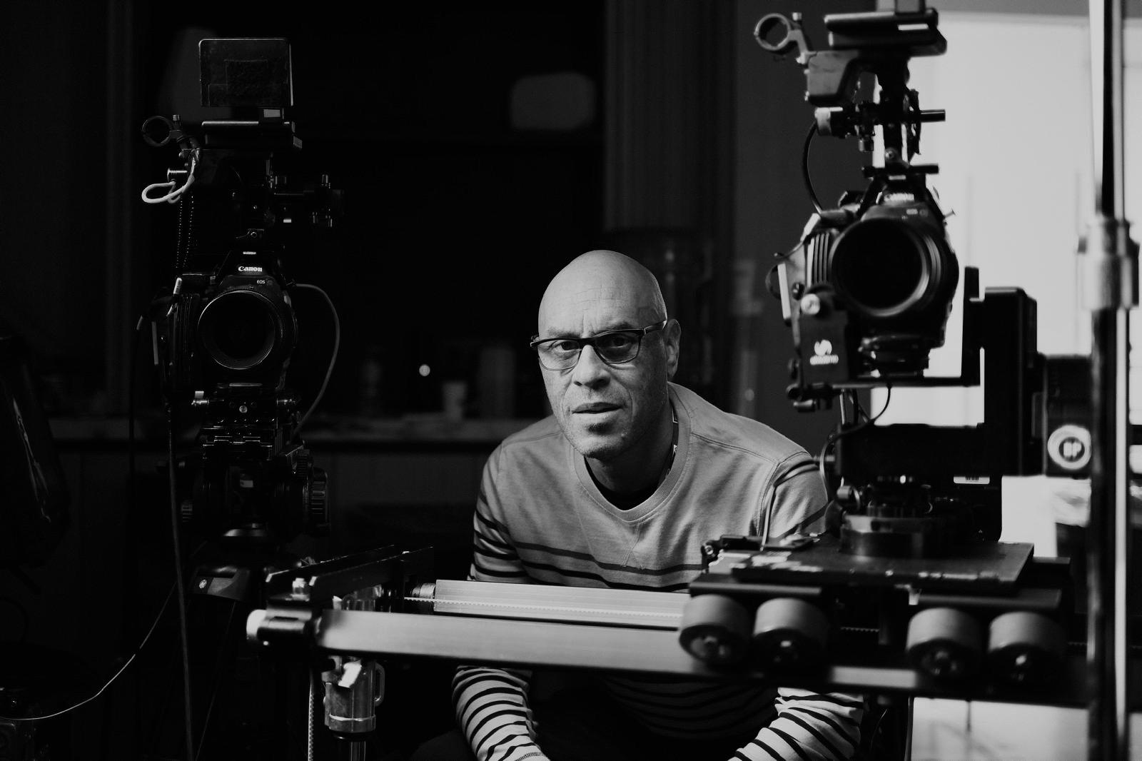 Graham Howe framed between two cinema cameras on set
