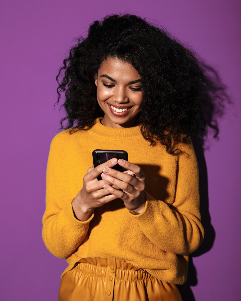 Woman smiling while checking her phone