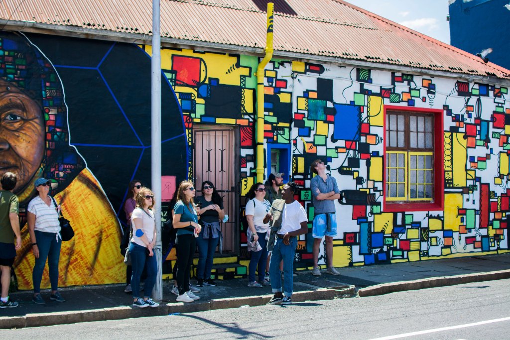 Guests photographing a mural in Salt River