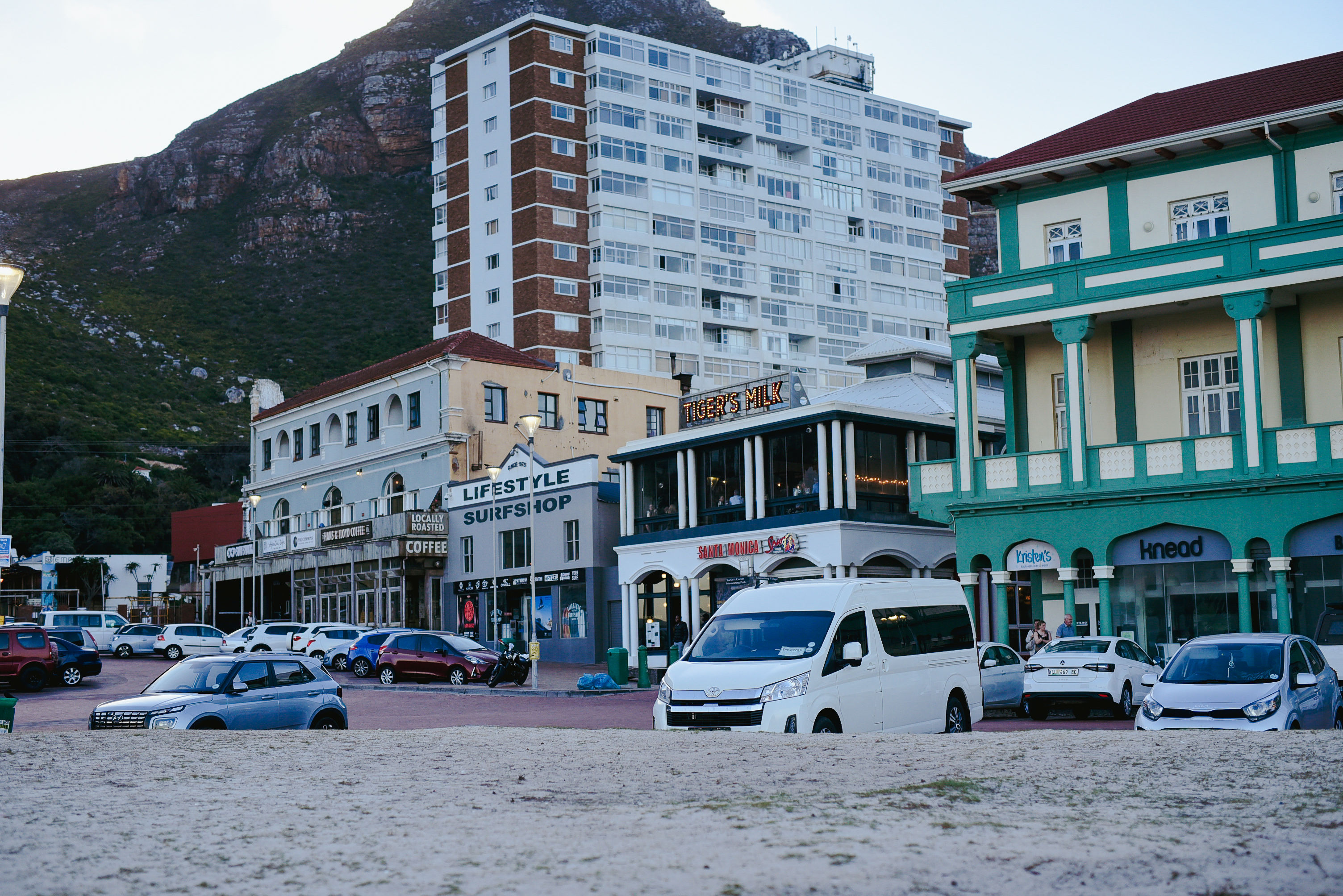 Muizenberg beachfront with its cafés and surf shops beneath the mountain