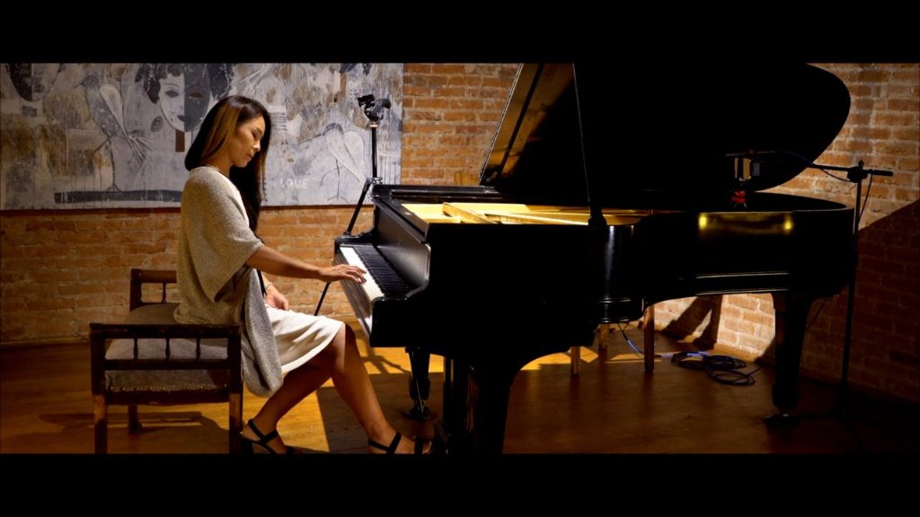 Yoko at the grand piano in the salon