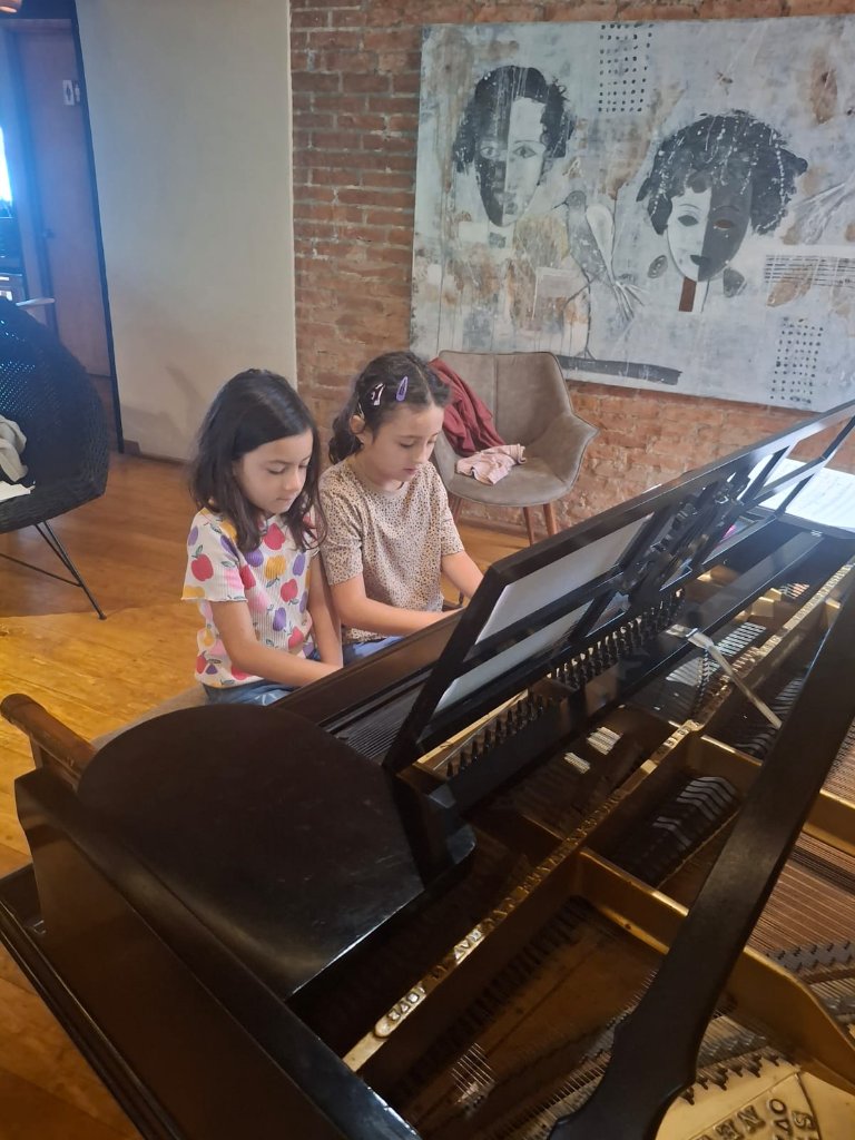 Children learning piano together
