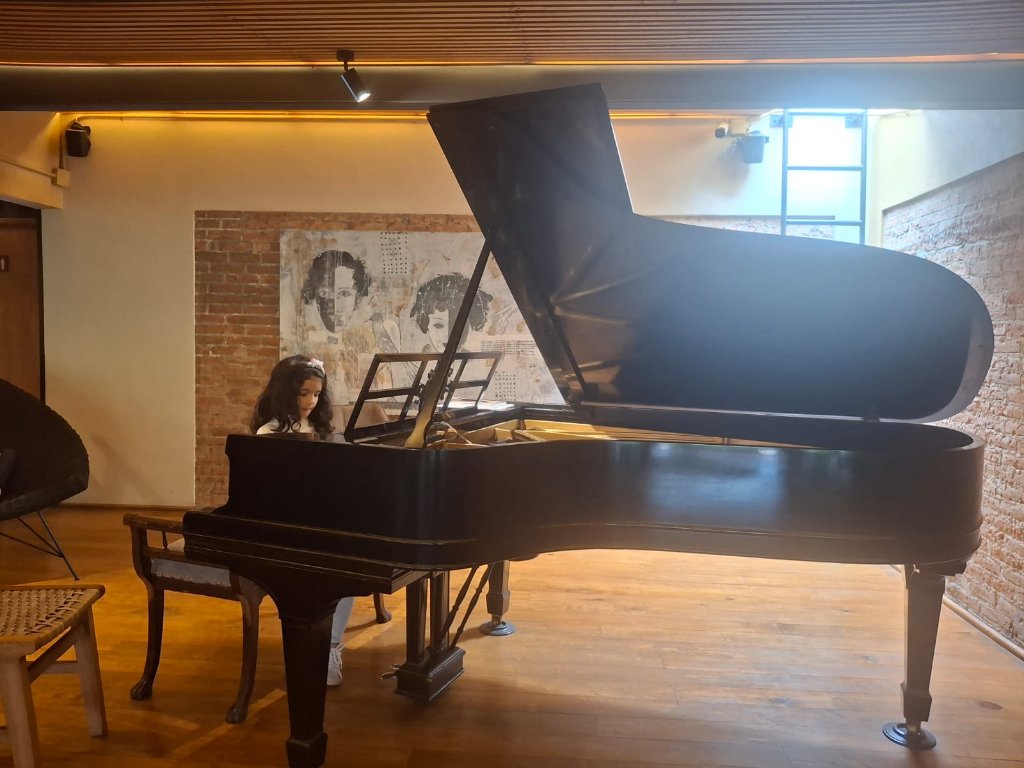 Young student at grand piano