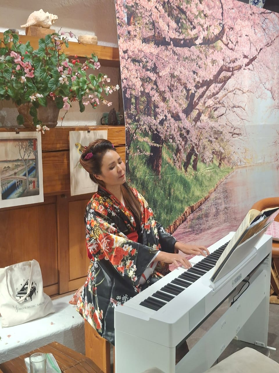 Yoko performing on white piano in kimono