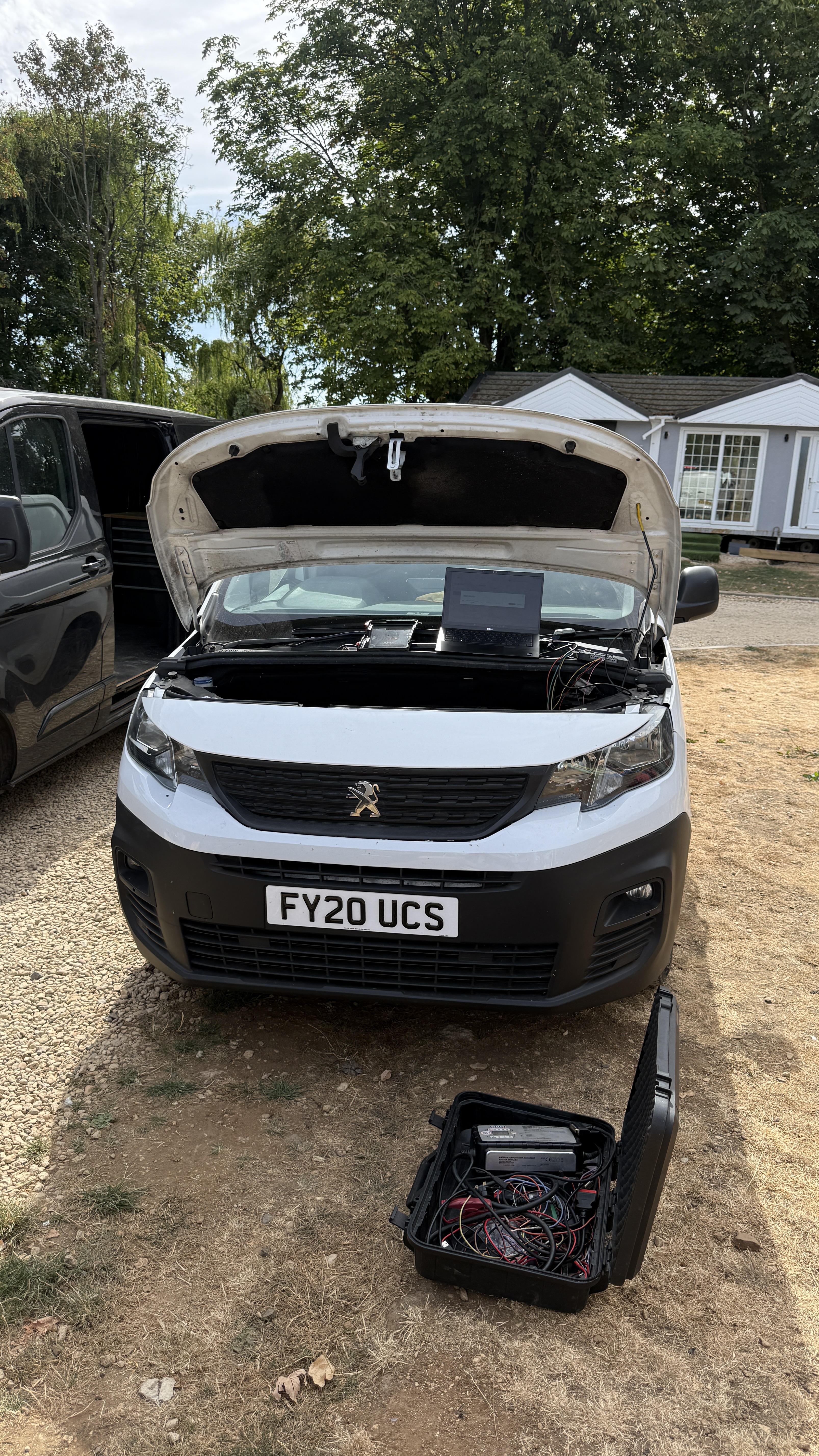 White Peugeot Partner van with bonnet open and laptop connected to the ECU on the engine, AdBlue delete carried out by KeyLogik in Cassington, Oxford