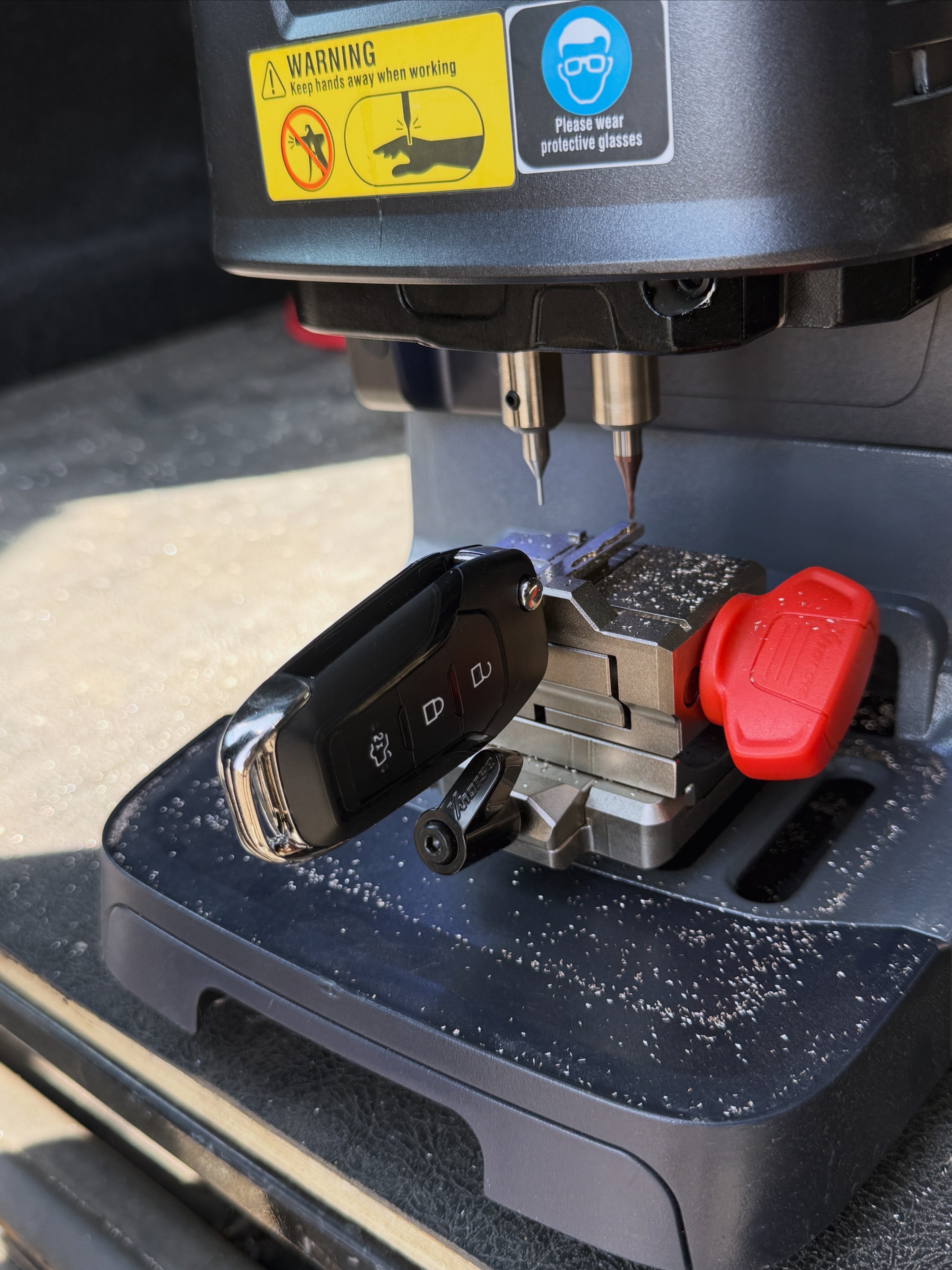 Ford flip key blade being precision cut on KeyLogik's key cutting machine