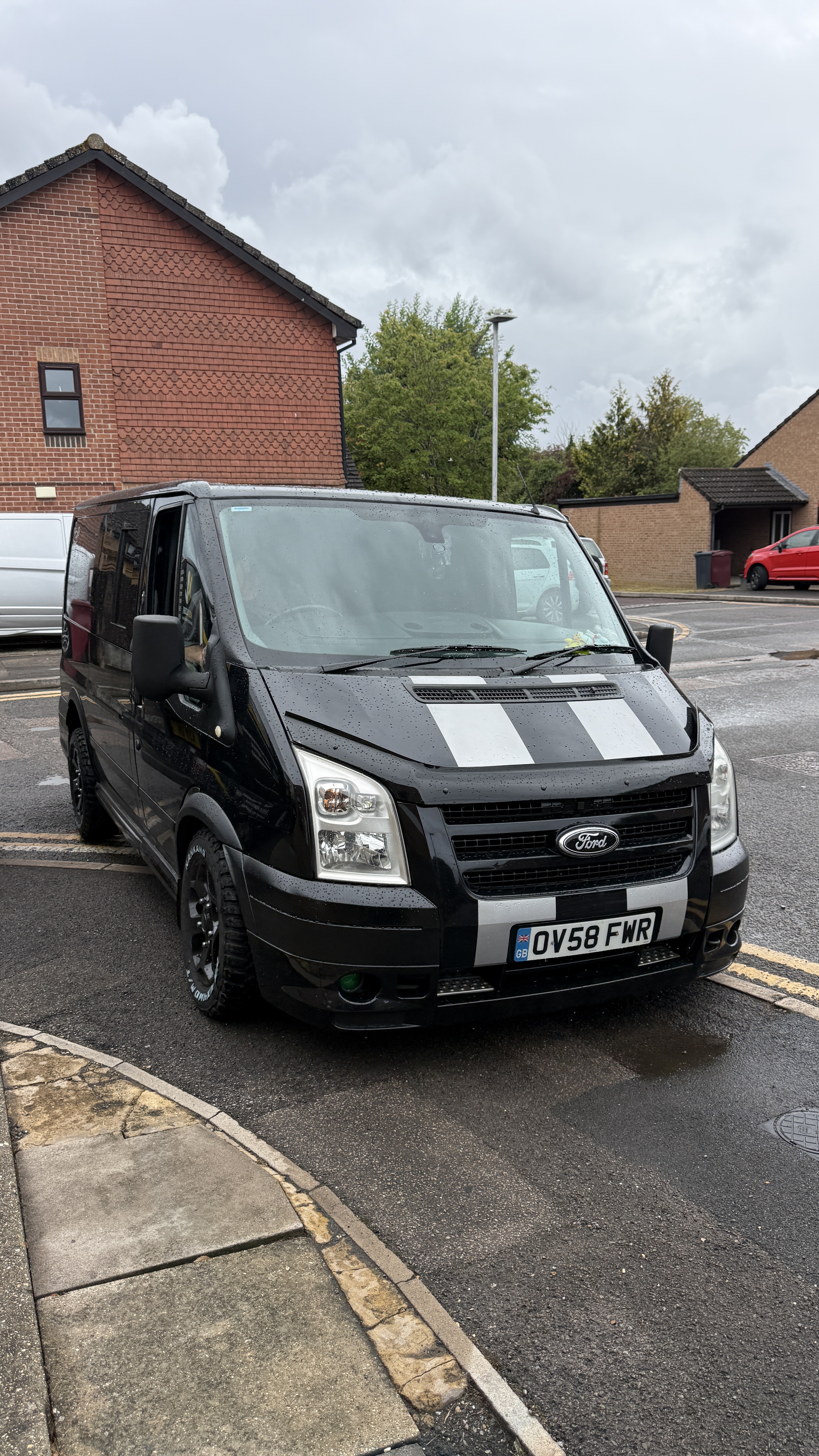 Black Ford Transit Mk7 2.4 TDCi van parked on a street, Stage 1 remap with DPF and EGR delete carried out by KeyLogik in Whitley Wood, Reading