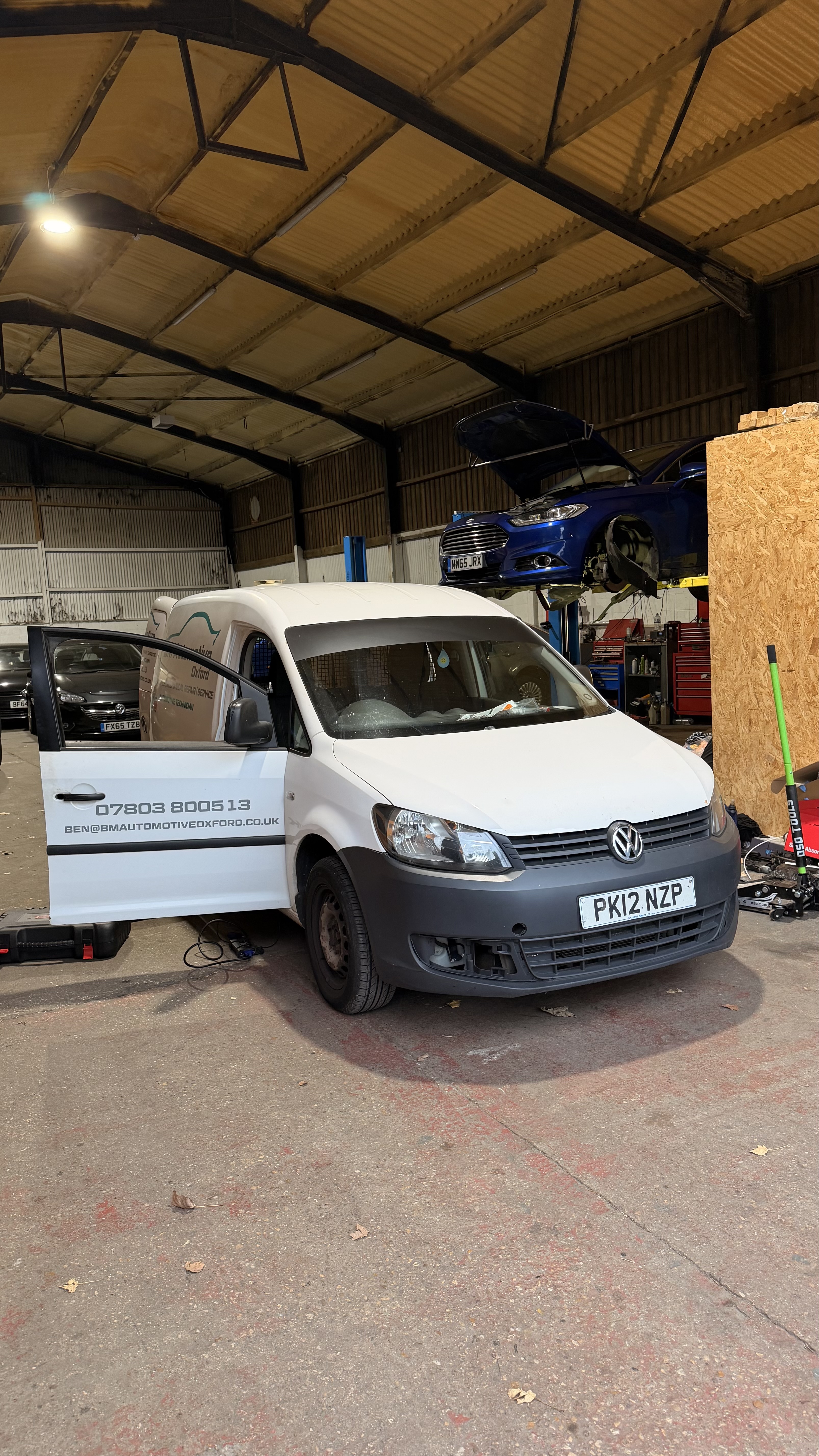 White Volkswagen Caddy van attended at a workshop by KeyLogik mobile auto locksmith