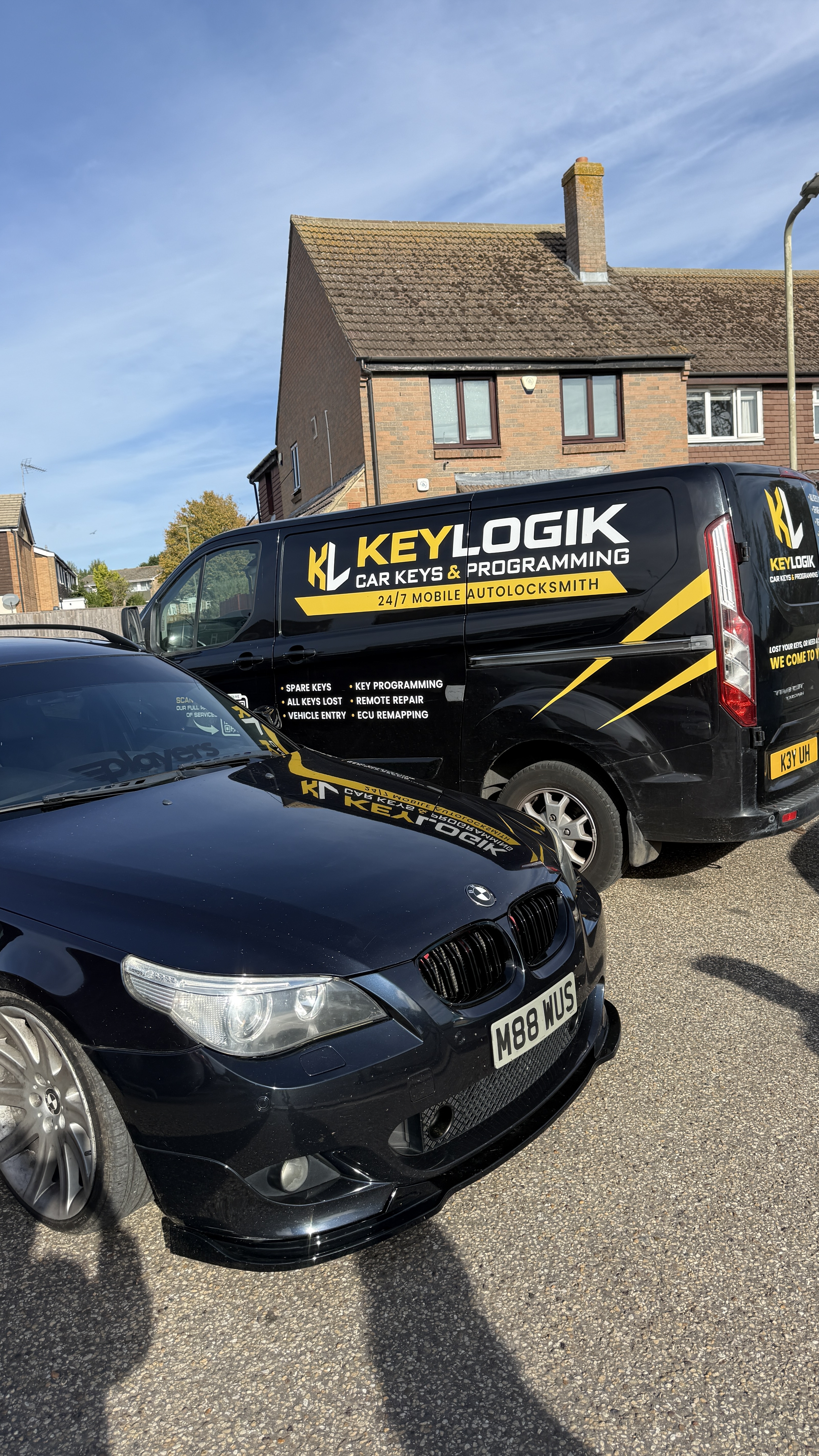 Black BMW 535d touring parked next to the KeyLogik mobile van after ECU remapping work was completed